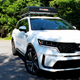 A photo of the front left quarter of a right Kia Sorento hybrid SUV.